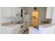 White kitchen with appliances and a small pantry at 10024 Heathcliff St, Spring Hill, FL 34608