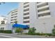 Modern condo building with blue awning entrance at 1050 Riverside Dr # A201, Palmetto, FL 34221