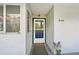 Condo unit entrance with blue door and potted plants at 1050 Riverside Dr # A201, Palmetto, FL 34221