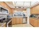 Well-equipped kitchen with stainless steel appliances and wood cabinets at 1050 Riverside Dr # A201, Palmetto, FL 34221