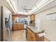 Spacious kitchen with island, stainless steel appliances, and ceiling fan at 1050 Riverside Dr # A201, Palmetto, FL 34221