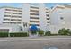 Building exterior featuring a multi-story building with landscaping and parking at 1050 Riverside Dr # A201, Palmetto, FL 34221