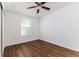 Cozy bedroom with dark brown wood flooring and a window at 106 E Calhoun St, Plant City, FL 33563