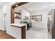 Modern kitchen with white cabinets, quartz countertops, and stainless steel appliances at 106 E Calhoun St, Plant City, FL 33563