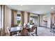 Bright dining area with view to backyard and access to the kitchen at 18006 Tavernside Trl, Lakewood Ranch, FL 34211