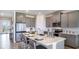 Modern kitchen with gray cabinets, quartz countertops, and breakfast bar at 18006 Tavernside Trl, Lakewood Ranch, FL 34211