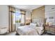 Spacious bedroom with large window, plush bed, and stylish nightstands at 18006 Tavernside Trl, Lakewood Ranch, FL 34211