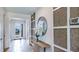 Elegant entryway with console table, mirror, and unique wall decor at 18006 Tavernside Trl, Lakewood Ranch, FL 34211
