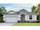 Single story home with light gray exterior and two car garage at 18006 Tavernside Trl, Lakewood Ranch, FL 34211