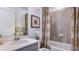 Bathroom with shower/tub combo, vanity with quartz countertop, and decorative accents at 18006 Tavernside Trl, Lakewood Ranch, FL 34211