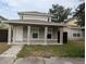 Two-story house with a front porch and landscaped yard at 2406 E 31St Ave, Tampa, FL 33610