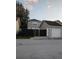 View of house exterior, detached garage, and fenced backyard at 2406 E 31St Ave, Tampa, FL 33610