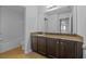 Bathroom with granite countertop and dark brown vanity at 2811 Maple Brook Loop, Lutz, FL 33558