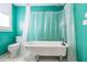 Bathroom with clawfoot tub and teal walls at 2908 N Central Ave, Tampa, FL 33602