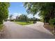 Circular driveway of mediterranean home with lush landscaping and rod iron entry gate at 306 Blanca Ln, Tampa, FL 33606