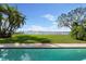 Backyard pool overlooking the tranquil waters and the city skyline in the distance at 306 Blanca Ln, Tampa, FL 33606