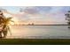 Stunning waterfront view featuring lush lawn, palm trees, and the beautiful city skyline at 306 Blanca Ln, Tampa, FL 33606