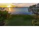 Scenic sunset view over calm water with lush green grass at 306 Blanca Ln, Tampa, FL 33606