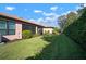 Landscaped backyard, showing home's exterior and grassy area at 306 Silver Falls Dr, Apollo Beach, FL 33572