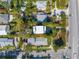 Aerial view of a house with lush landscaping and proximity to neighborhood and road at 3302 E Maritana Dr, St Pete Beach, FL 33706