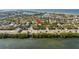 Wide-angle aerial view of waterfront real estate amidst lush greenery and sparkling blue waters at 3302 E Maritana Dr, St Pete Beach, FL 33706