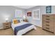 Bright bedroom with light blue walls, shuttered windows, and a comfortable bed with stylish decor at 3302 E Maritana Dr, St Pete Beach, FL 33706