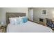 Bedroom features a wood headboard, desk, and coastal-themed accents at 3302 E Maritana Dr, St Pete Beach, FL 33706