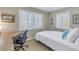 Bedroom featuring two shuttered windows and a desk area at 3302 E Maritana Dr, St Pete Beach, FL 33706