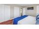 Bedroom with hardwood floors, double closets, and blue and white bedding creates a calm, inviting atmosphere at 3302 E Maritana Dr, St Pete Beach, FL 33706