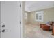 Bright room with plantation shutters, tile floors, and a cozy seating area near the windows at 3302 E Maritana Dr, St Pete Beach, FL 33706