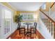 Cozy dining area with a small table and chairs near large windows and staircase at 3302 E Maritana Dr, St Pete Beach, FL 33706