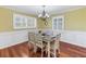 Inviting dining room features wainscoting, plantation shutters, and a stylish chandelier at 3302 E Maritana Dr, St Pete Beach, FL 33706