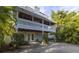 Charming two-story home featuring a spacious balcony and lush greenery at 3302 E Maritana Dr, St Pete Beach, FL 33706
