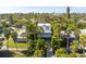 Charming two-story home with a white facade, front porch, and lush tropical landscaping at 3302 E Maritana Dr, St Pete Beach, FL 33706