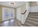 Inviting foyer with decorative tile flooring, glass doors, and staircase to the upper level at 3302 E Maritana Dr, St Pete Beach, FL 33706