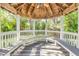 Charming gazebo with built-in seating, perfect for outdoor relaxation and gatherings at 3302 E Maritana Dr, St Pete Beach, FL 33706