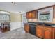 Charming kitchen featuring dark wood cabinets, granite countertops, and a view to the dining area at 3302 E Maritana Dr, St Pete Beach, FL 33706