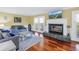 Cozy living room features a fireplace, hardwood floors, and comfortable seating at 3302 E Maritana Dr, St Pete Beach, FL 33706