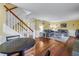Open-concept living room featuring hardwood floors and access to staircase at 3302 E Maritana Dr, St Pete Beach, FL 33706