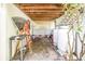 Covered outdoor area with stone floor, storage, and lattice providing shade and privacy at 3302 E Maritana Dr, St Pete Beach, FL 33706