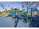 Colorful playground equipment with slides, climbers, and a soft blue surface for safe play at 3302 E Maritana Dr, St Pete Beach, FL 33706