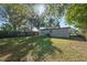 Large grassy backyard with mature trees and a wooden fence at 3305 W Kathleen St, Tampa, FL 33607