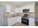 Renovated kitchen with white shaker cabinets and stainless steel appliances at 3305 W Kathleen St, Tampa, FL 33607