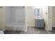 Bathroom with gray vanity, white tile, and updated toilet at 3305 W Kathleen St, Tampa, FL 33607