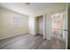 Well-lit bedroom with wood-look floors and a large closet at 3305 W Kathleen St, Tampa, FL 33607