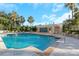 Beautiful outdoor pool with clear blue water, palm trees, and lounge chairs at 345 Bayshore Blvd # 610, Tampa, FL 33606