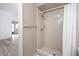 Bathroom shower featuring white tile and floors with neutral paint at 3454 Hillmoor Dr, Palm Harbor, FL 34685