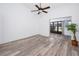 Bright bedroom with modern floors, access to a screened-in porch, and a tranquil view at 3454 Hillmoor Dr, Palm Harbor, FL 34685