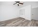 Cozy bedroom with wood flooring, a ceiling fan, and a closet, creating a peaceful retreat at 3454 Hillmoor Dr, Palm Harbor, FL 34685