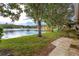 Peaceful backyard oasis with lake view and patio at 3454 Hillmoor Dr, Palm Harbor, FL 34685